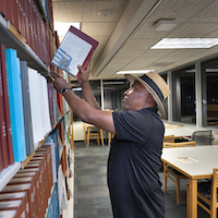 Samuel Holloway III in the library at night.