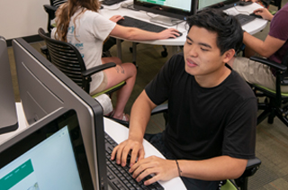 student sitting at a computer