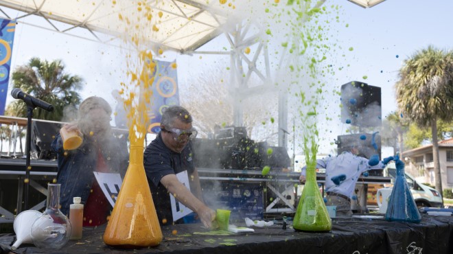 Colorful liquids erupting from science beakers