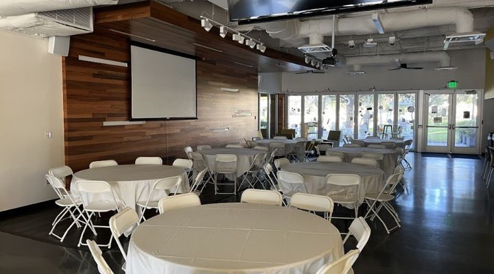 Round tables with white linen surrounded by tables
