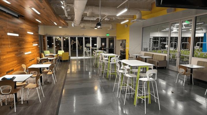 A mix of hightop tables and lounge couches