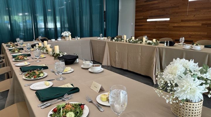 Table set with gray linens, plates, and silverware. Set for a meal