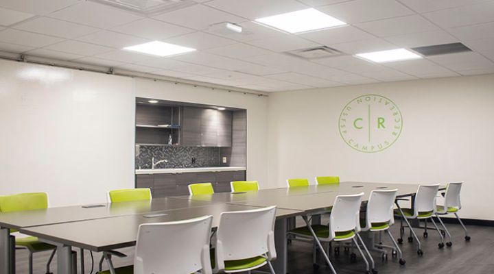 Large, long conference table surrounded by chairs