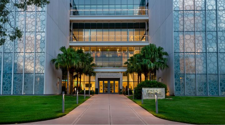 Large building with two sides filled with large windows.