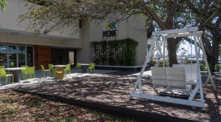 The outside of the Edge building with a swingset