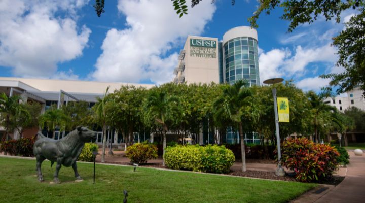 Large building with lots of windows in a cylinder like form