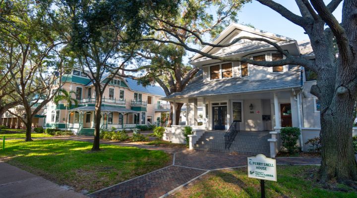 Two Victorian style homes with a courtyard in between them.