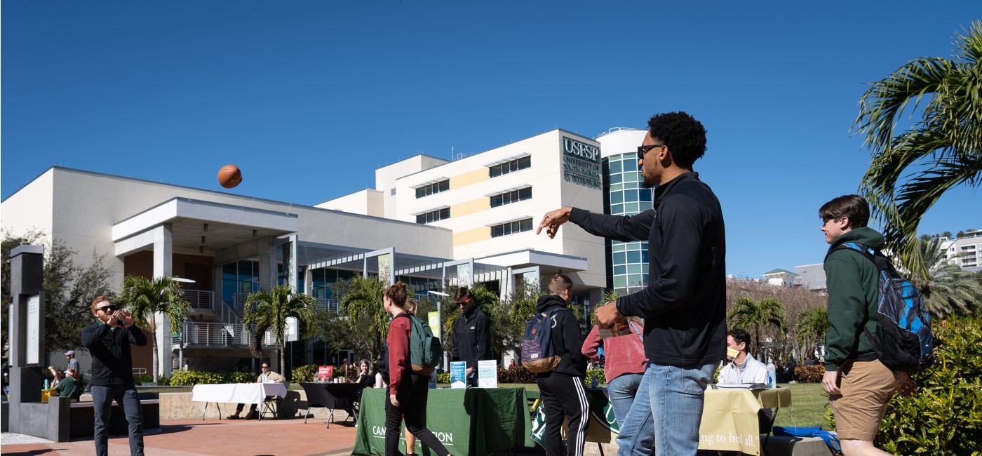 students throwing a football