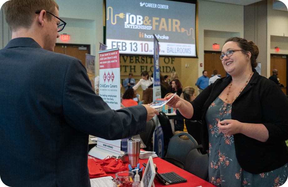 Two people introducing themselves over a table