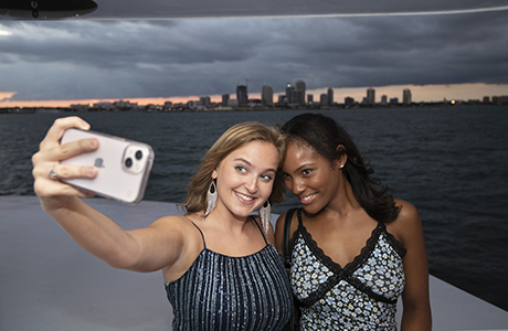 Students on a boat posing for a selfie