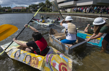 Students paddling cardboard boats