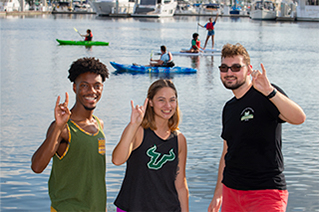 Students on Waterfront flashing bull hand sign