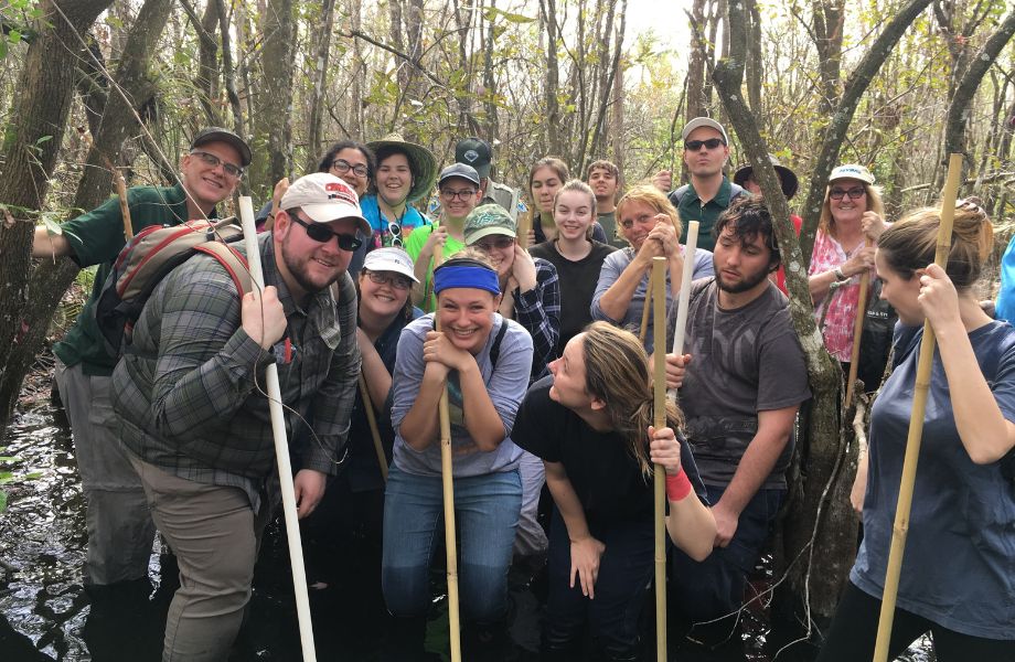 Group of students hiking in river