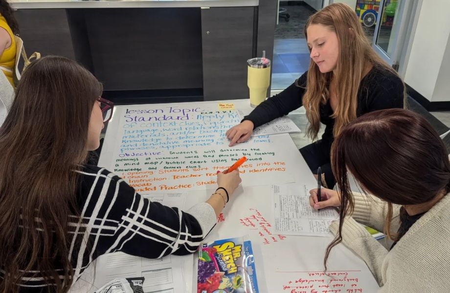 A group of students working on poster together.