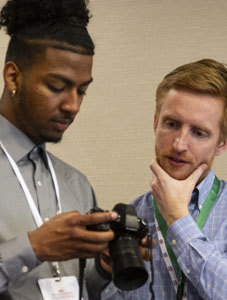 student and instructor examining digital camera