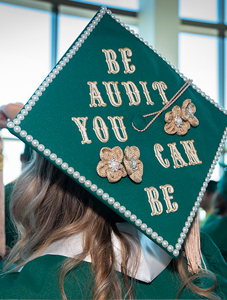 graduate mortar board with words "be audit you can be"