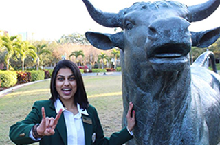 female student with bull statue