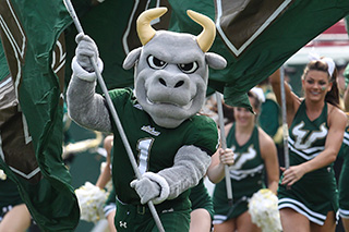 Rocky running with flag at USF Football game