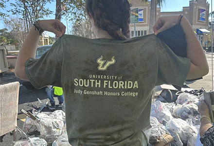 female student wearing USF Judy Genshaft Honors College logo shirt