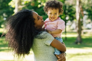 Mohter holding a smiling child