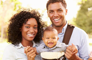 young family with baby in carrier