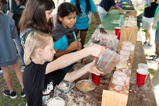 Three young children doing a science experiment