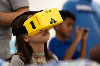 Child with a VR headset on looking up