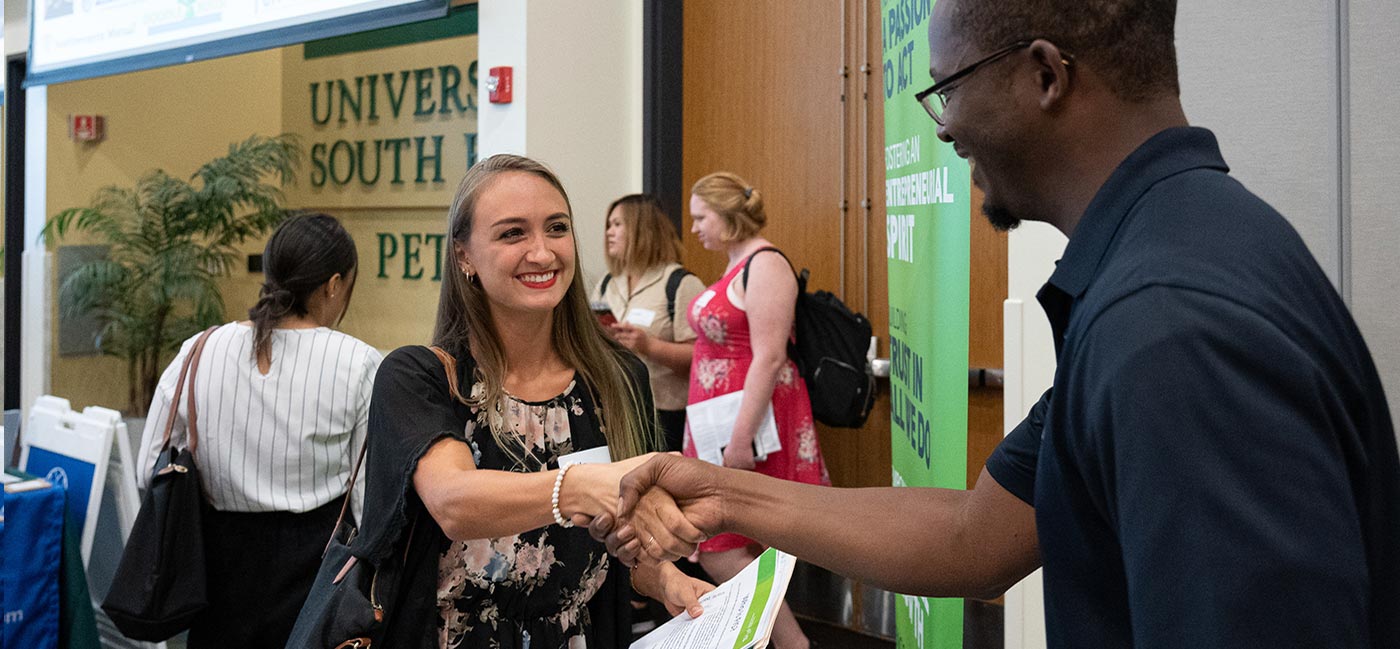 Employer shaking student hand