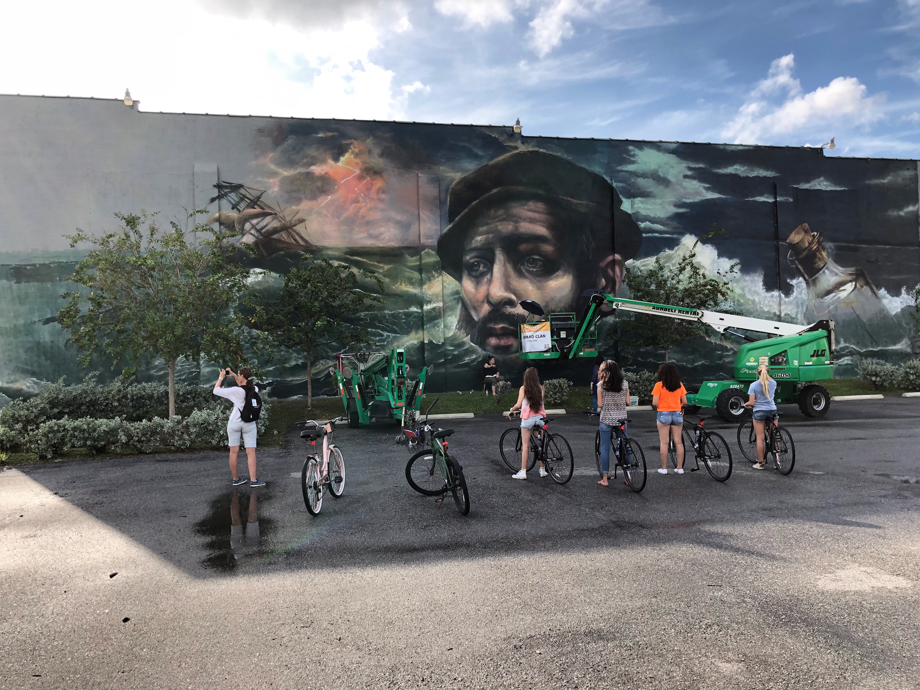 Bikers admire a mural in downtown St. Pete