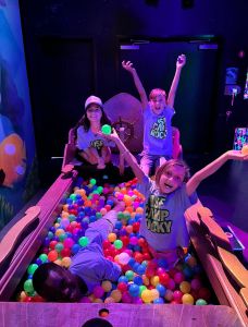 Students playing in ball pit.