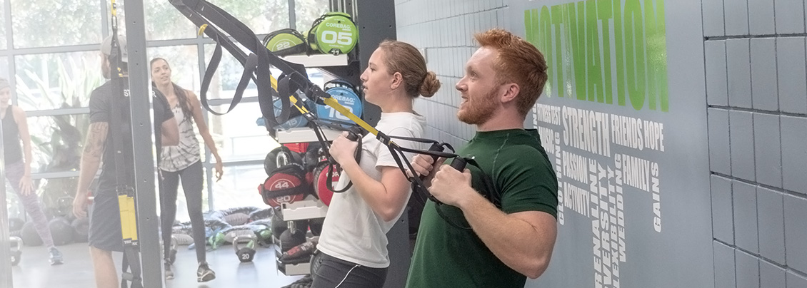 Two students workout in the fitness center