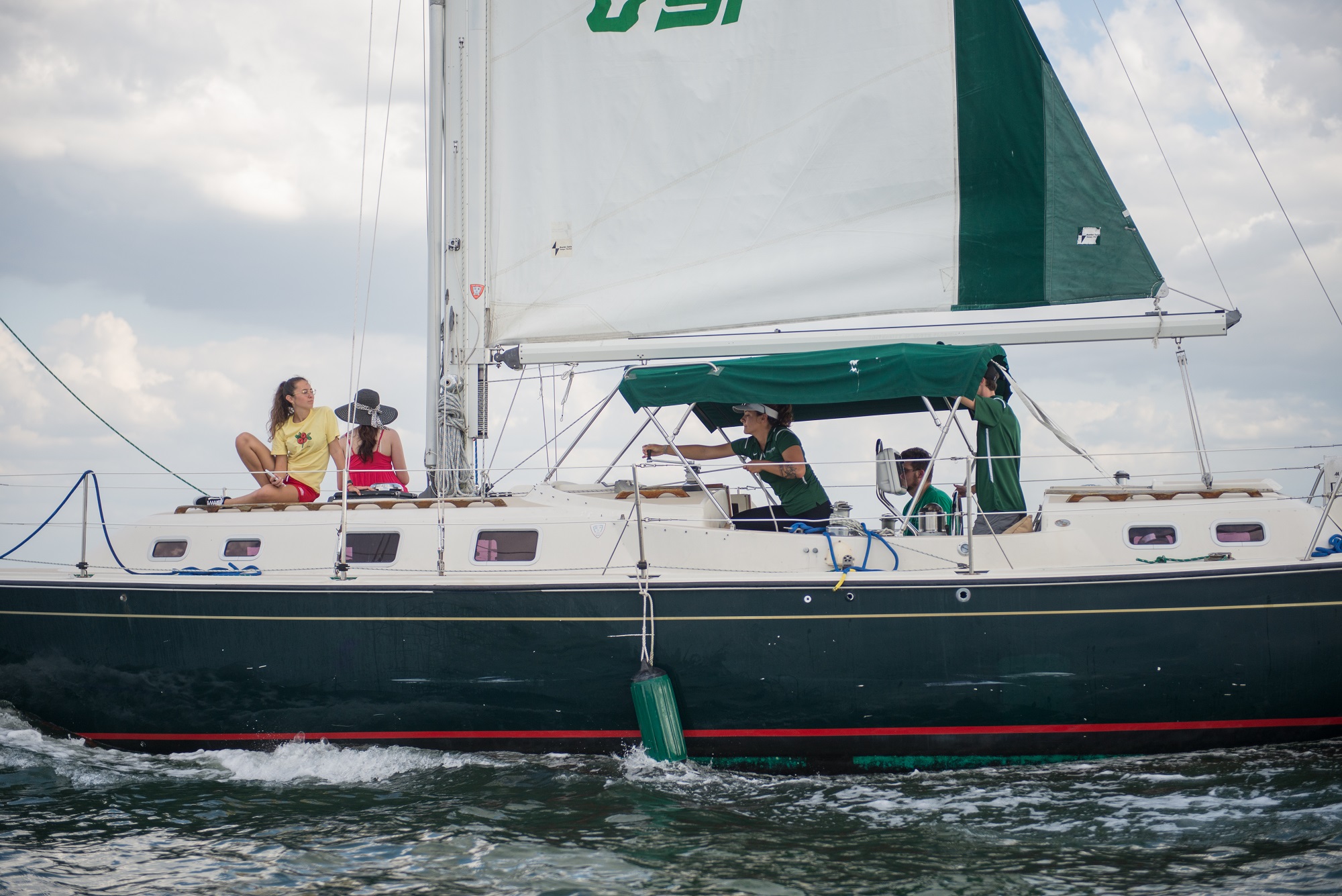 student sailing large boat