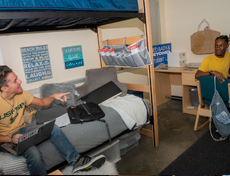 Student on bunkbed in USC residential room