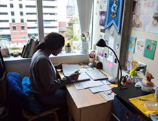 Student studying at desk by window in USC room