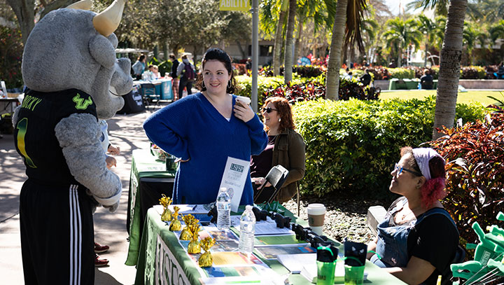 Students talk with Rocky, USF's Mascot, at the annual activities fair, Get on Board Day. 