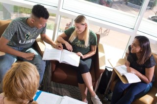 students with professor studing on the campus waterfront