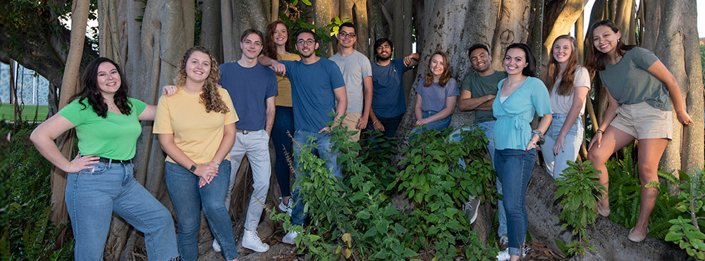 current student orientation leaders standing under banyon tree