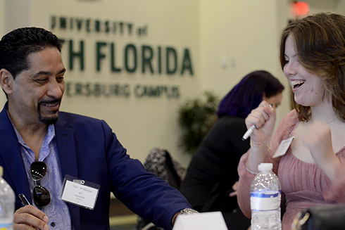 male mentor sitting at table with female student
