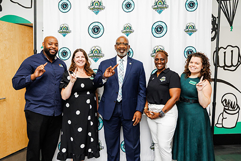 mayor ken welch with 4 other adults in front of a backdrop