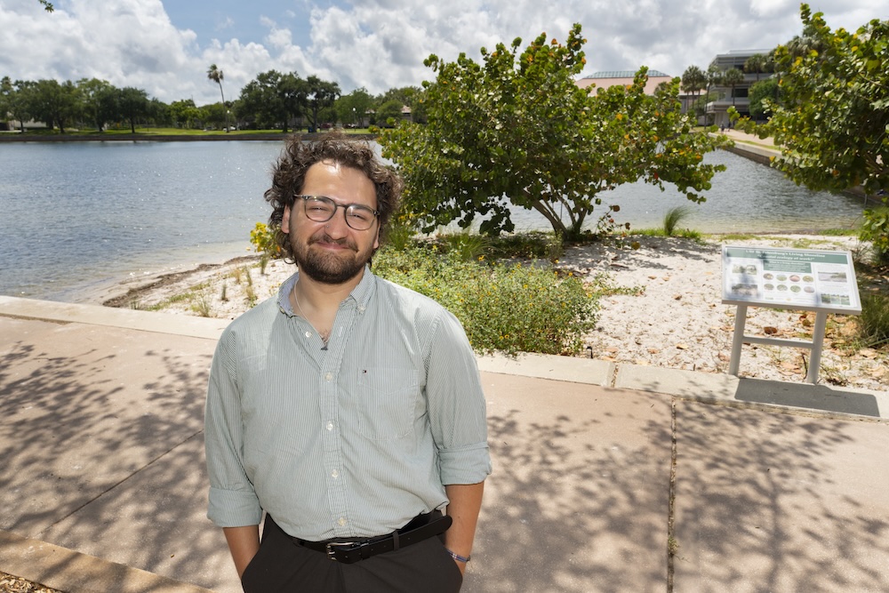 Oliver Laczko standing in front of the living shoreline project he helped create at USF St. Petersburg.