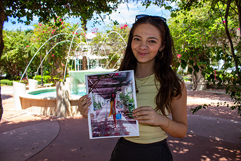 Madison Badertscher in front of campus fountains.