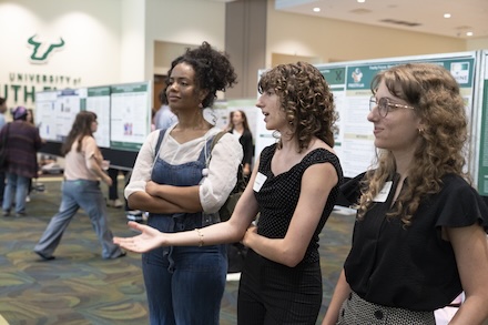 Autumn (left) and Haley (right) Merkle present their findings on the endangered Anoa to an attendee.