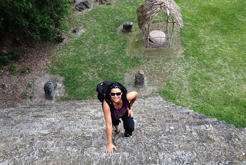 Lori Singleton climbing a Mesoamerican pyramids during an archeological dig.