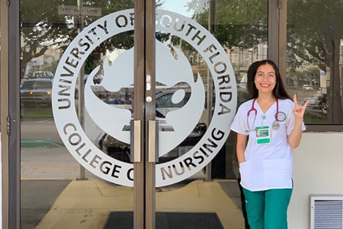 Victoria Hernandez in front of the College of Nursing