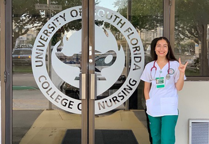 Victoria Hernandez in front of the College of Nursing.