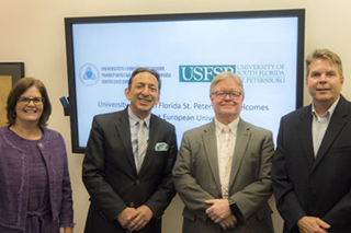 USFSP Political Science Professor Judithanne Scourfield McLauchlan, Reka, Tadlock and College of Arts and Sciences Dean Frank Biafora pose after the signing event.