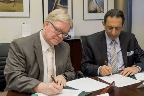 Interim Regional Chancellor Martin Tadlock and Professor Blerim Reka from South East European University sign the collaboration agreement.