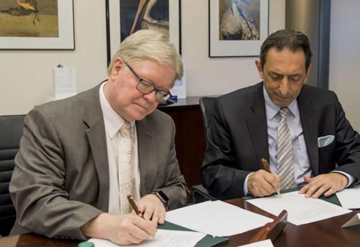 Interim Regional Chancellor Martin Tadlock and Professor Blerim Reka from South East European University sign the collaboration agreement.