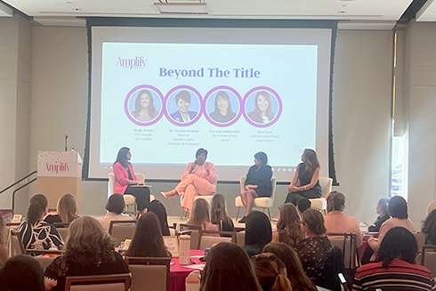 four women on stage speaking during the amplify event