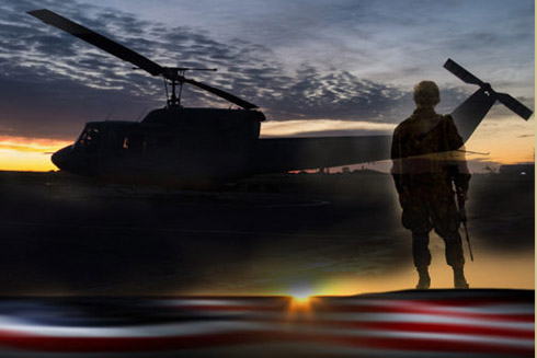 Member of the military in front of a helicopter.